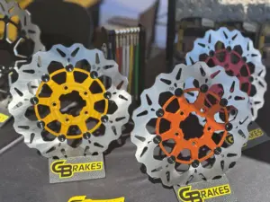 Display of GBrakes custom motorcycle brake rotors in different finishes, designed for performance and custom builders.